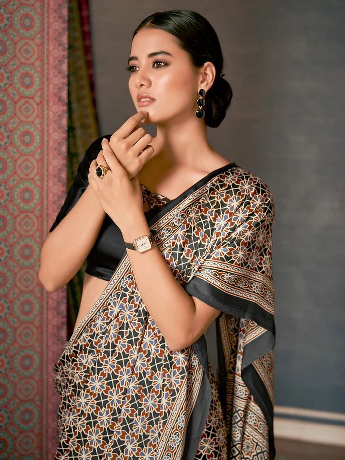 Close-up detail of the intricate geometric block print patterns on the soft indigo blue fabric drape