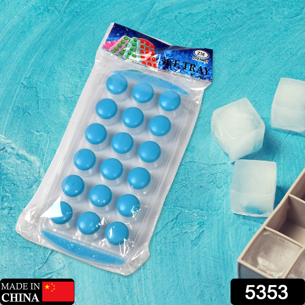 Hand pushing out a round mini ice cube from a flexible silicone tray.