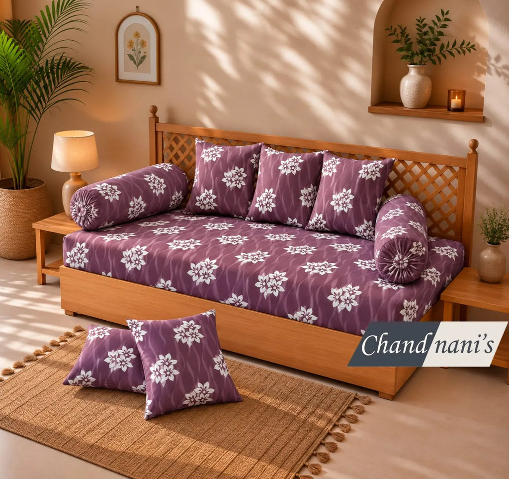 Purple floral print cotton diwan set with cushion and bolster covers on wooden diwan