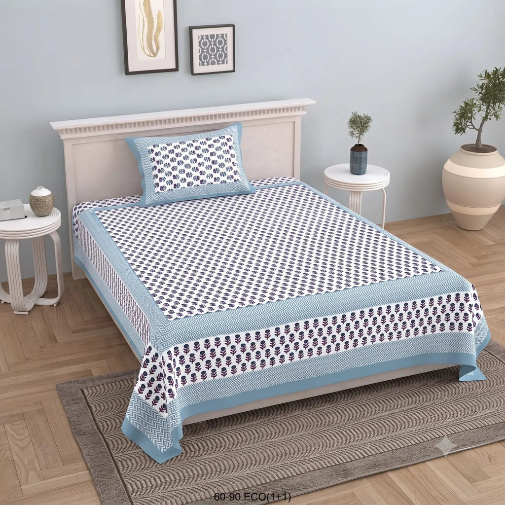 Blue and white floral print cotton single bedsheet on wooden bed with matching pillow cover