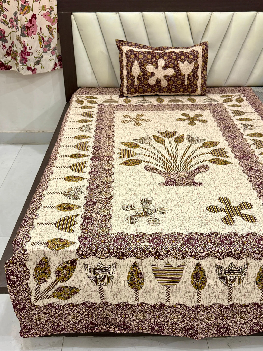 Maroon and mustard floral print single bedsheet with matching pillow cover on bed