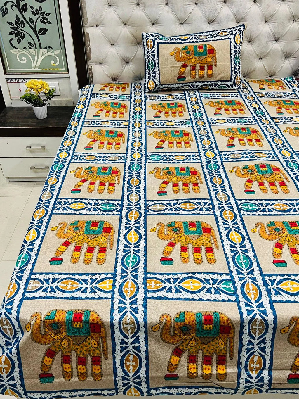 Beige single bedsheet featuring traditional colorful elephant print with pillow cover