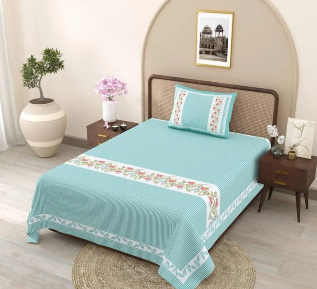 Teal striped single bedsheet with floral border and matching pillow cover on bed
