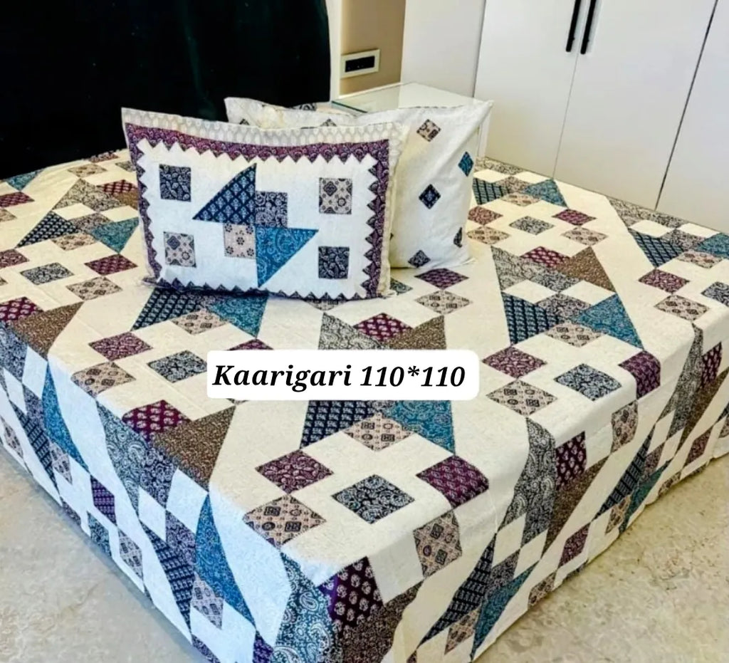 Blue geometric print cotton bedsheet with two matching pillow covers on bed