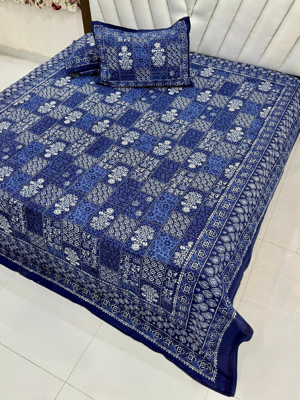 Blue patchwork print pure cotton super king bedsheet with matching pillow covers on bed
