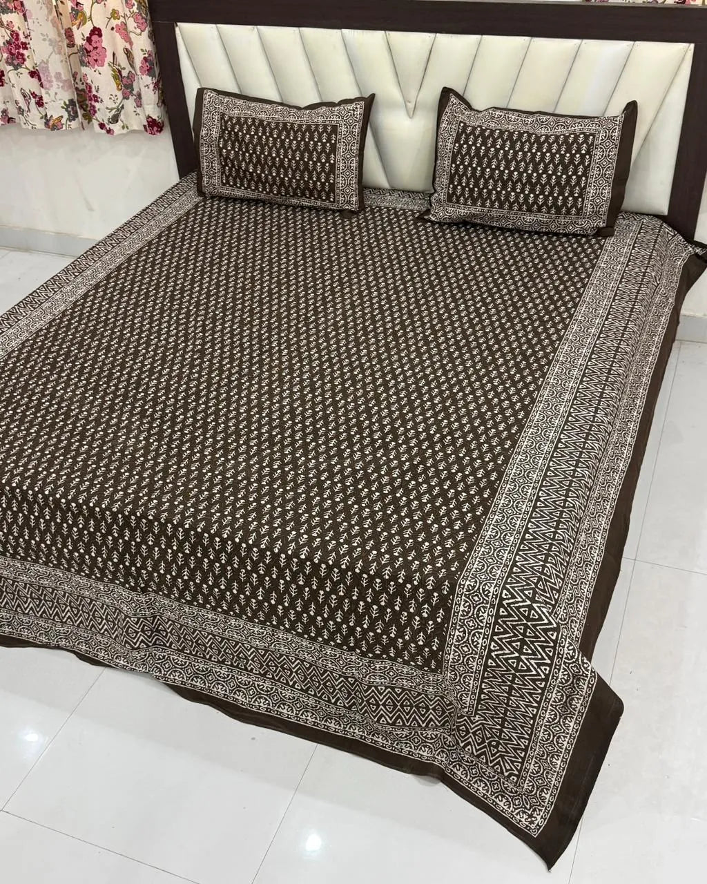 Brown floral print 100% pure cotton super king bedsheet spread on bed with two matching pillow covers