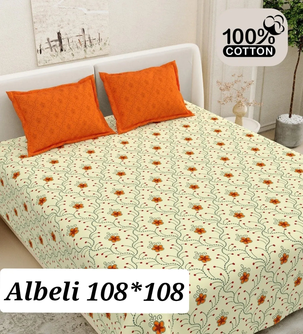 Cream and orange floral print cotton bedsheet with matching orange pillow covers on a bed