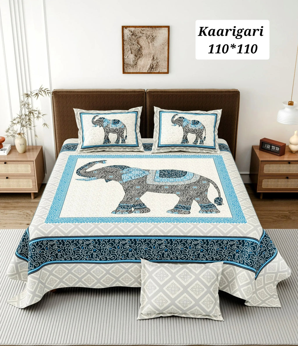 Blue and grey elephant print cotton bedsheet styled on a king size bed with two matching pillow covers