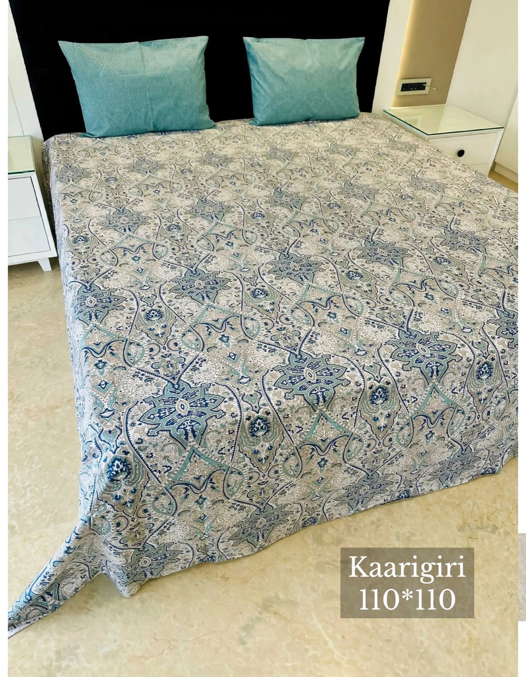 Blue paisley print cotton bedsheet on king size bed with two matching pillows