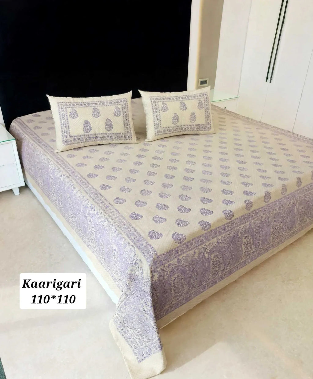 Purple floral Jaipuri cotton super king bedsheet 108x108 with matching pillow covers on bed