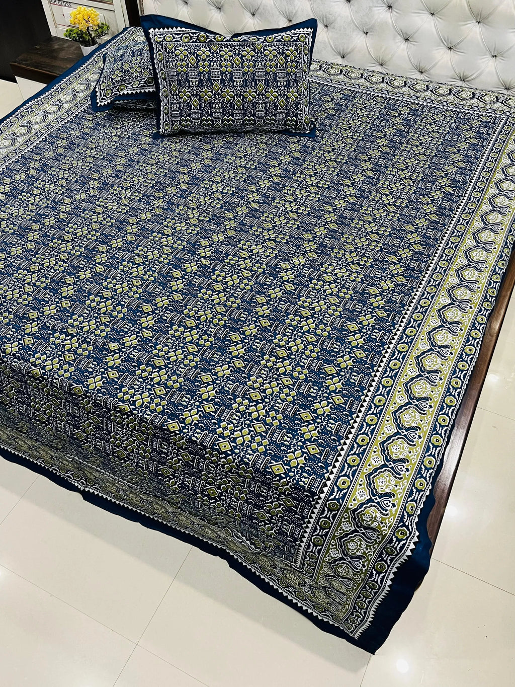 Navy blue geometric print pure cotton super king bedsheet with matching pillow covers on bed