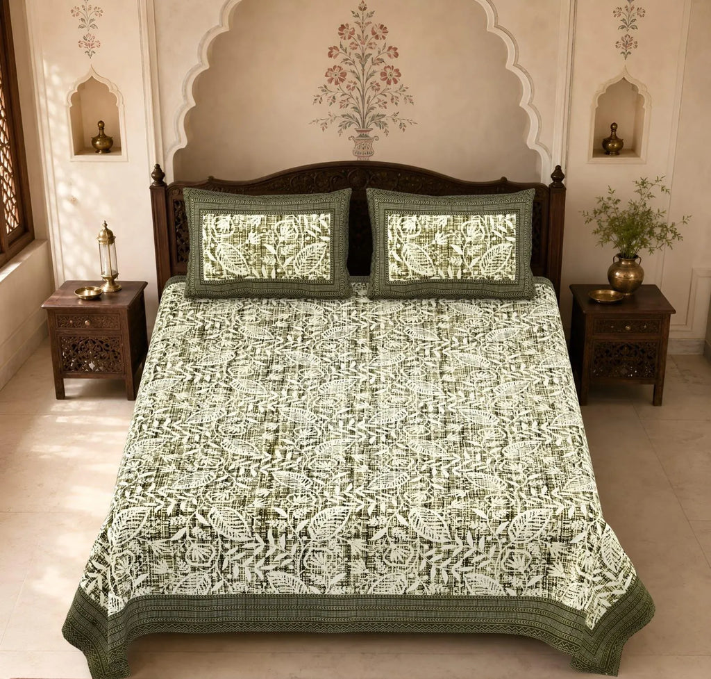 Olive green pure cotton super king bedsheet with leaf print and two matching pillow covers on bed