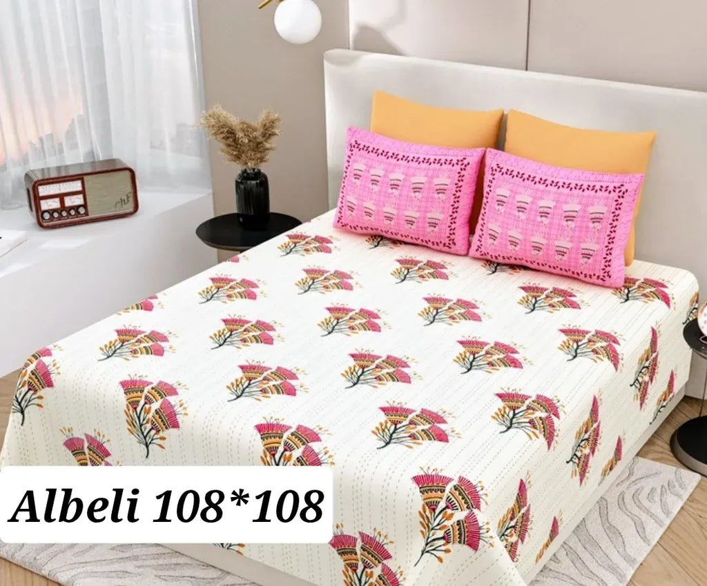 White cotton bedsheet with pink floral print and matching pillow covers on bed