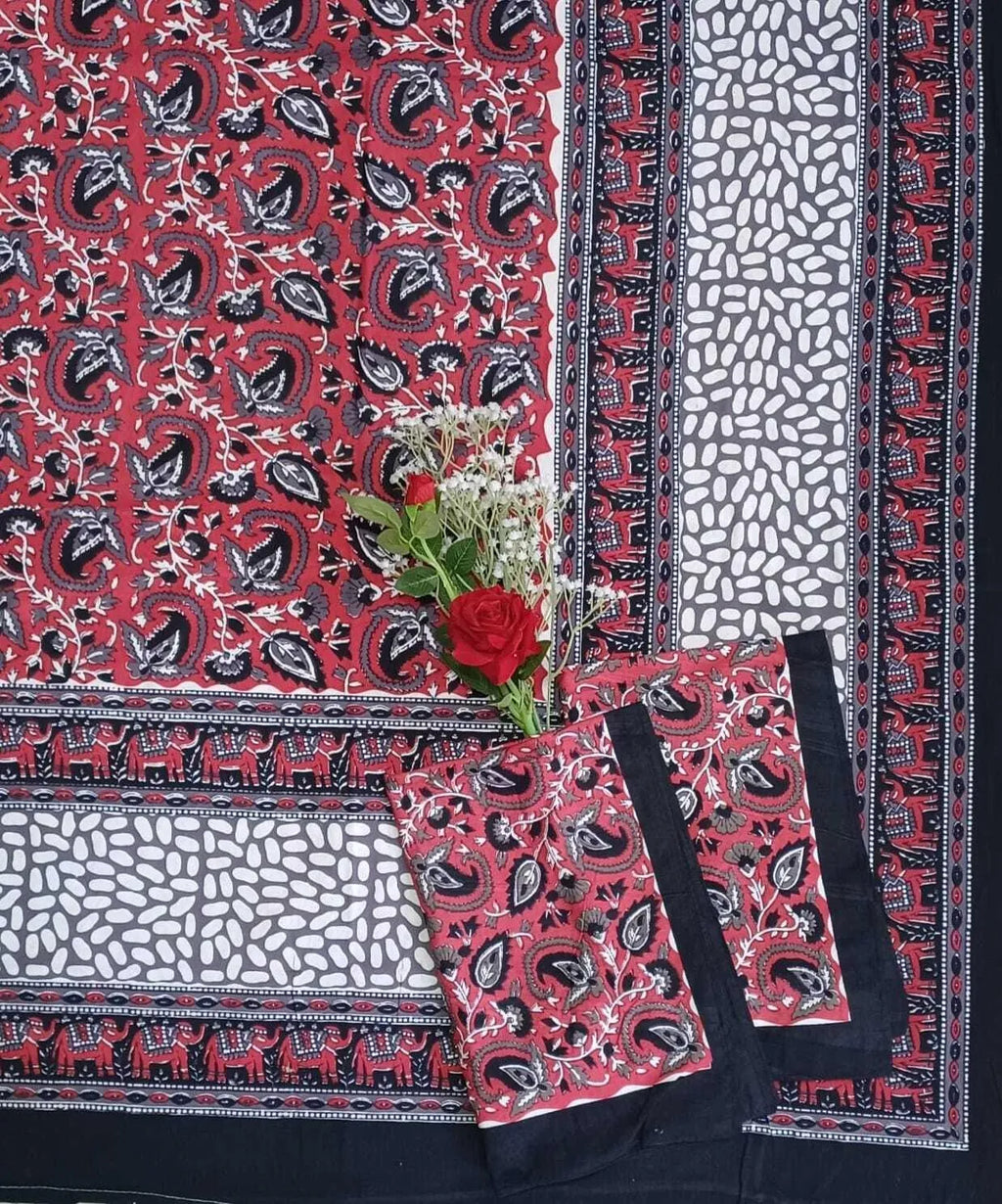 Red and black cotton bedsheet with paisley and elephant print flat lay