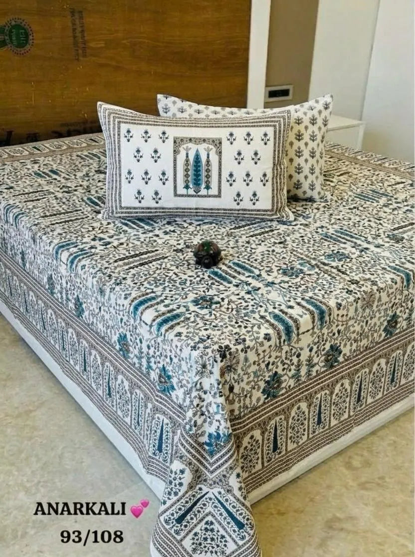 Teal and white floral print cotton super king bedsheet with matching pillow covers on bed