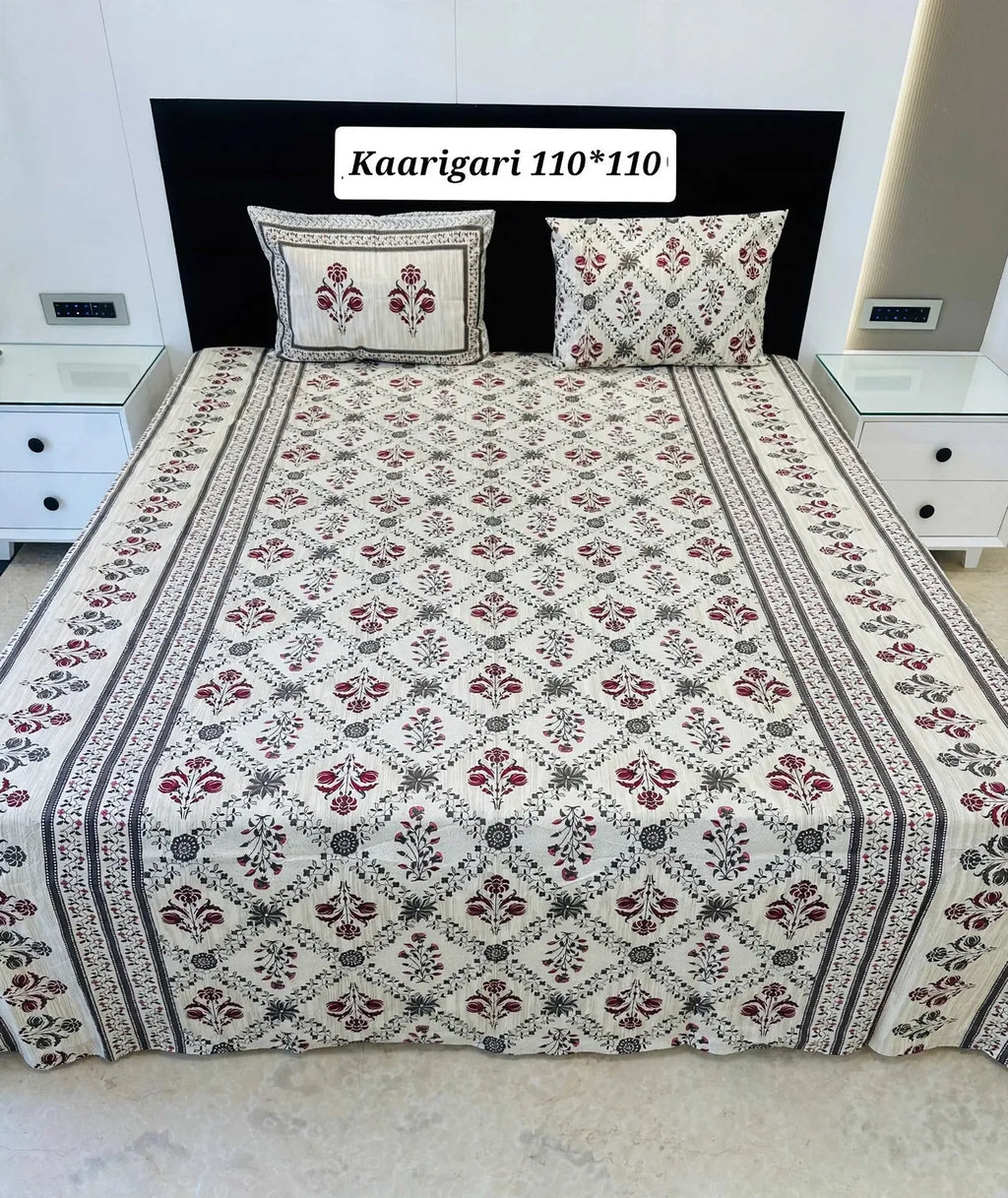 White and maroon Jaipuri print cotton bedsheet on a bed with two matching pillow covers