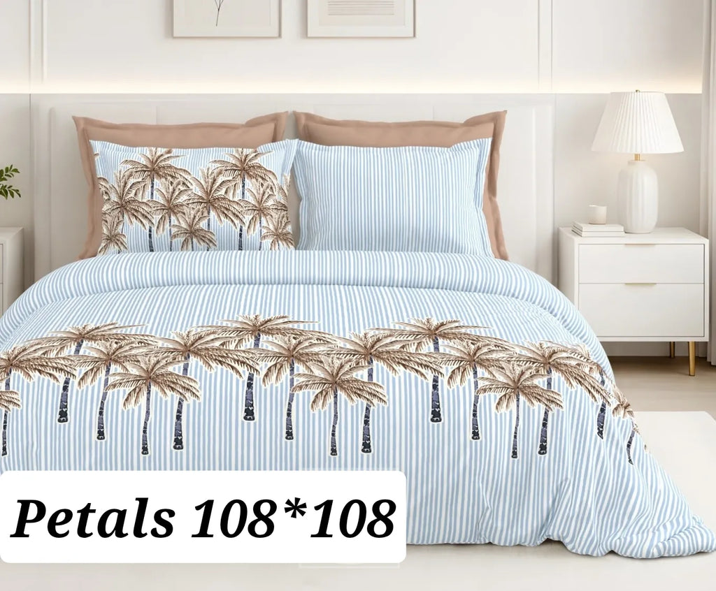 Blue and white striped cotton bedsheet with tropical palm tree print and two pillow covers on bed