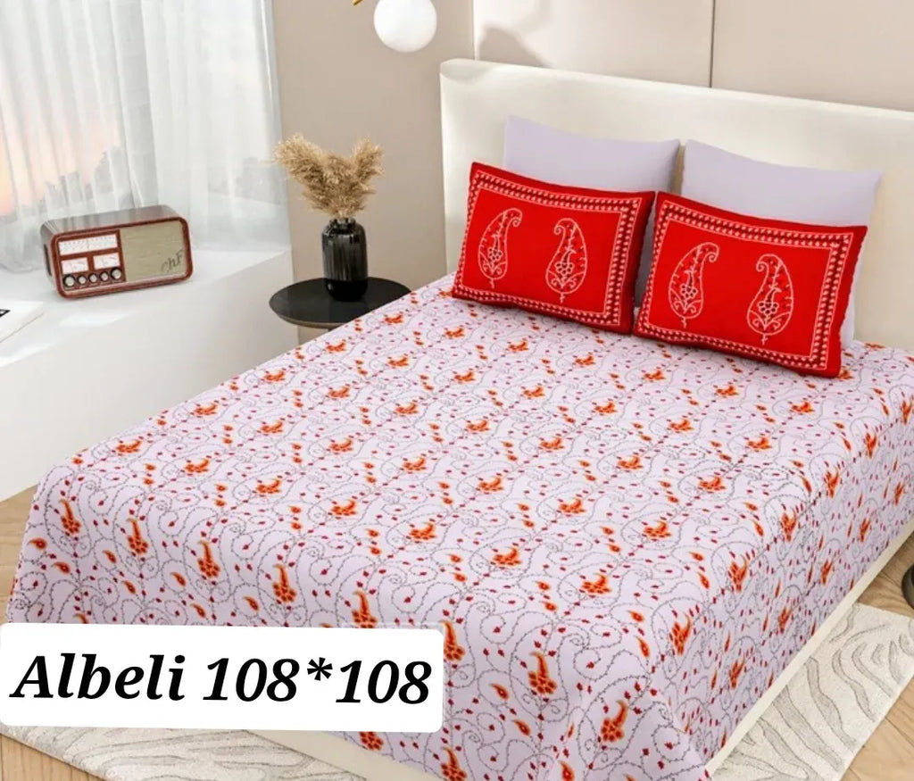 White and orange floral print cotton super king bedsheet with matching red pillow covers on a bed