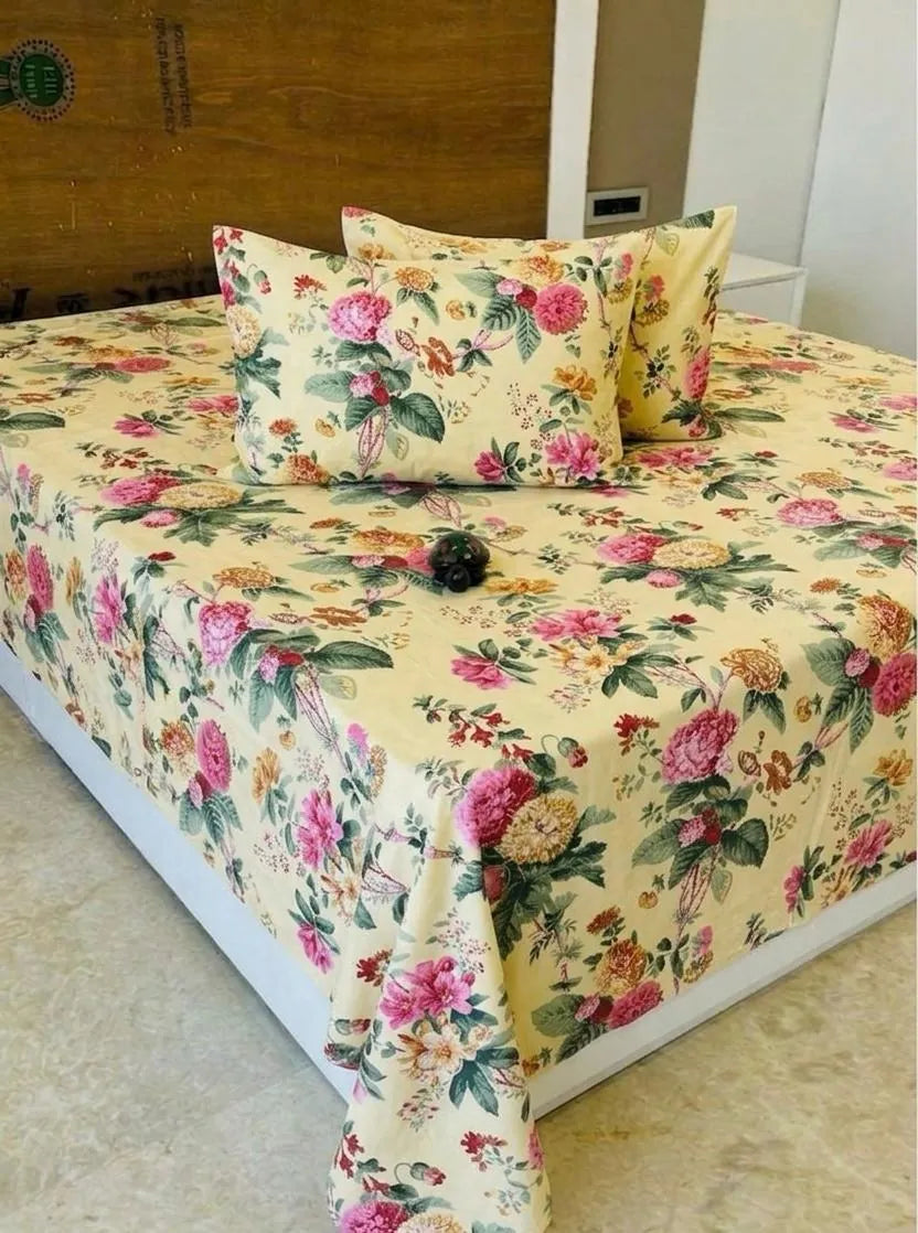 Yellow floral print cotton super king bedsheet with matching pillow covers on bed