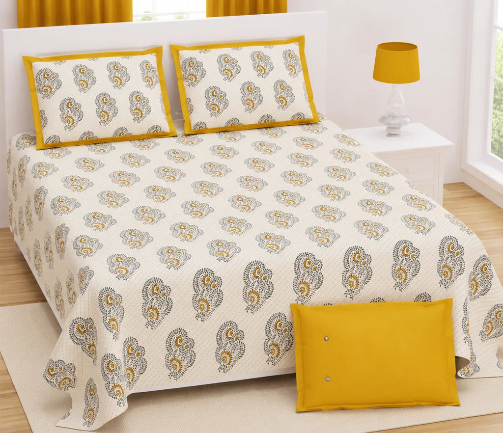 Super king size yellow paisley print cotton bedsheet with two matching pillow covers on a white bed