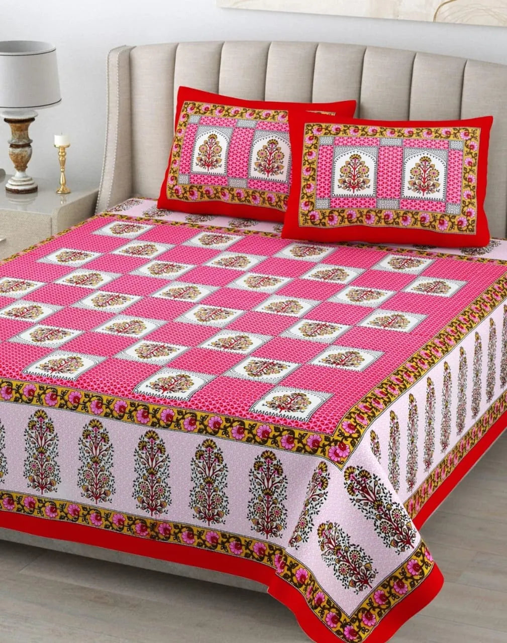 Pink floral print pure cotton bedsheet with two matching pillow covers on bed