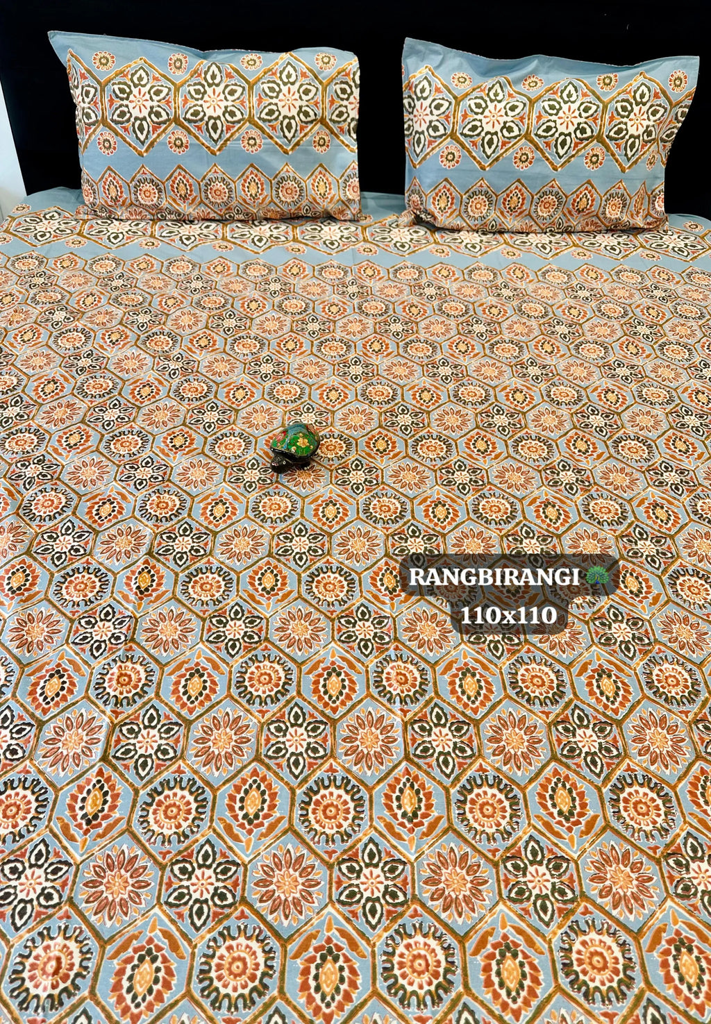 Light blue geometric print super king cotton bedsheet with matching pillow covers on bed