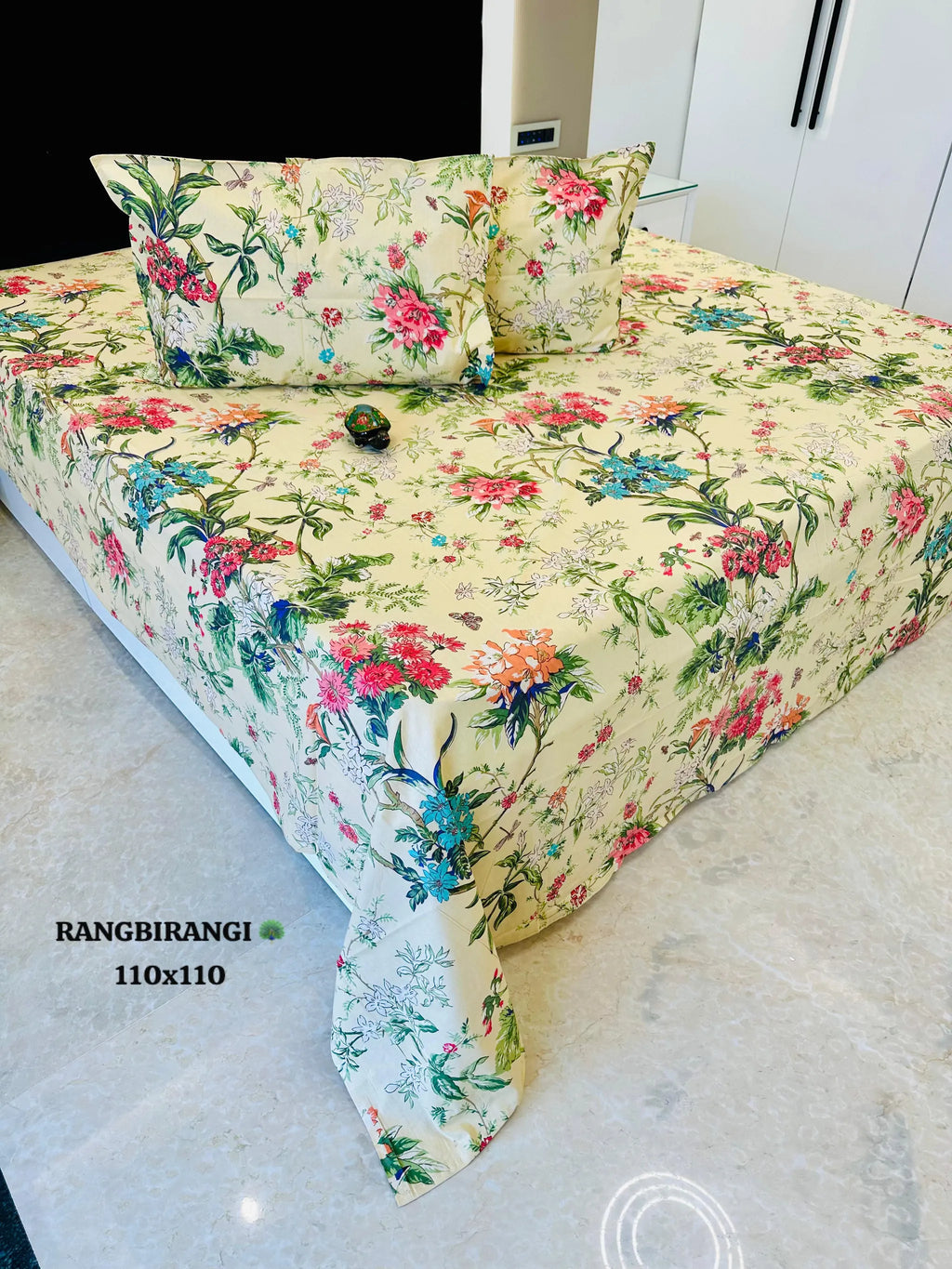 Cream floral print cotton super king bedsheet with two matching pillow covers on bed