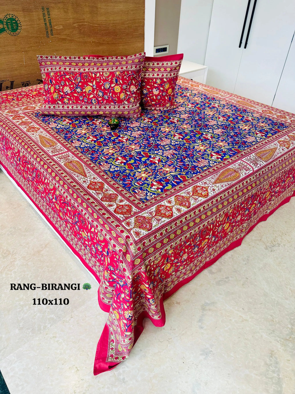 Red floral cotton super king bedsheet with pillow covers on bed