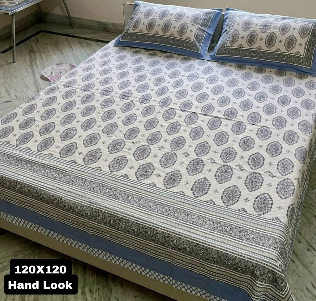 Blue and white geometric print super king bedsheet displayed on a bed with two matching pillow covers