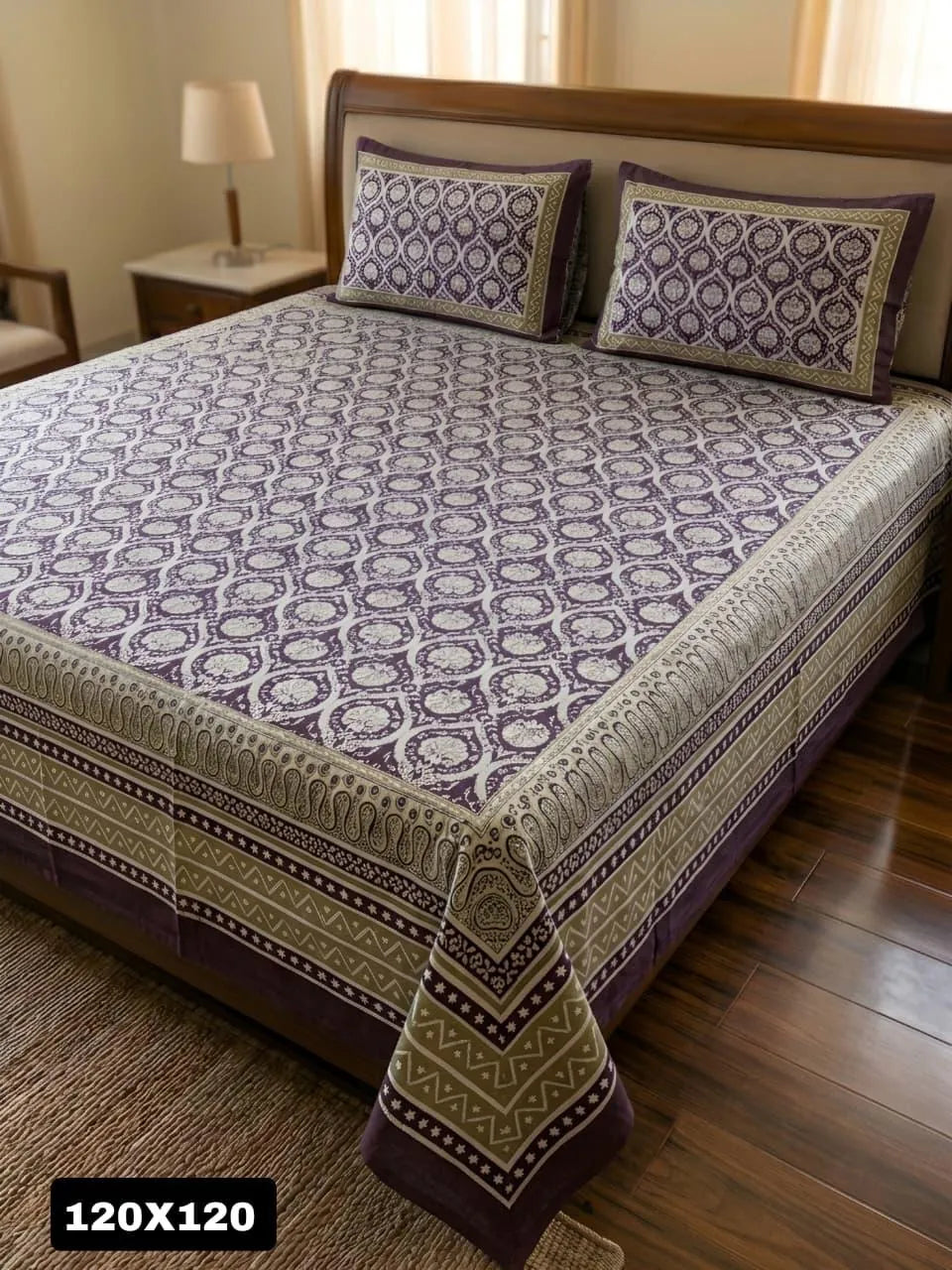 Purple damask print super king bedsheet with two matching pillow covers on bed