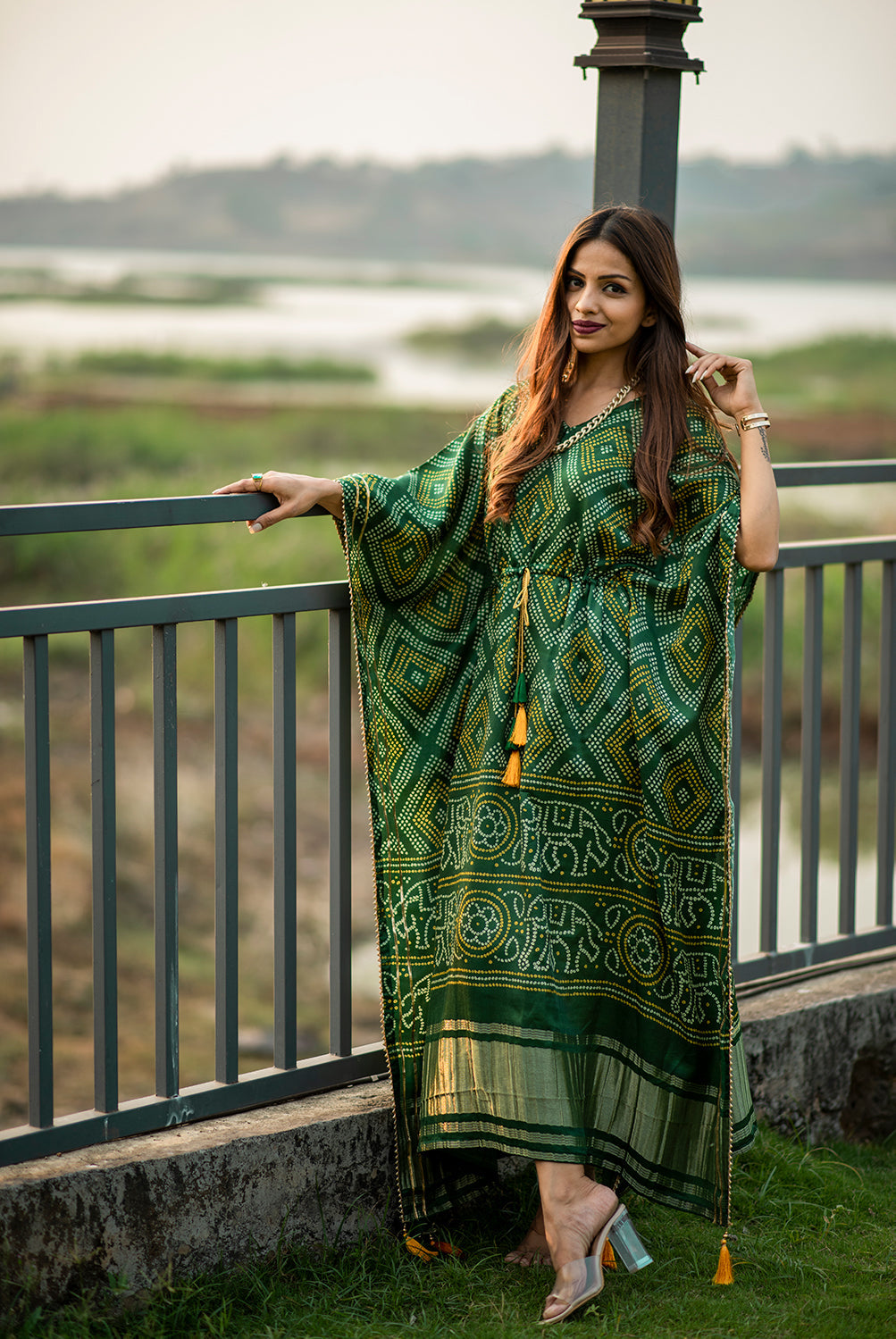 Close-up of intricate gold Gota Patti lace border on the green silk fabric