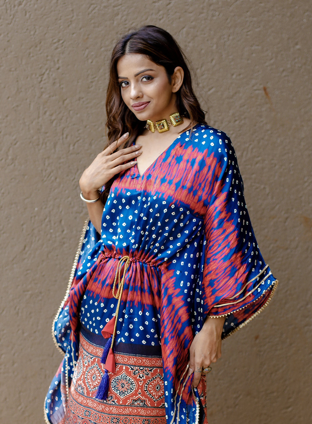 Close-up of the delicate gold Gotta Patti lace border and playful tassels on the sleeve hem.