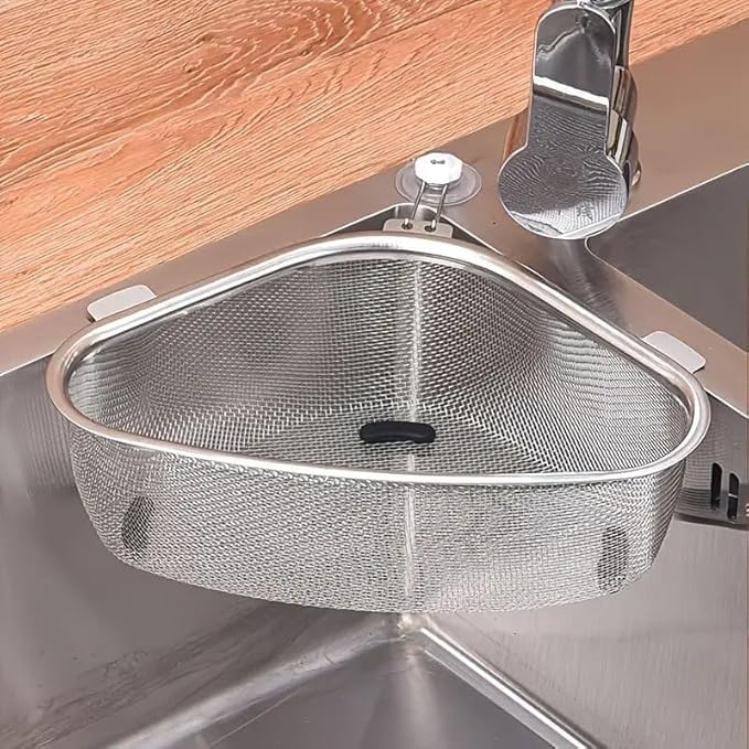 Stainless steel triangular sink corner strainer collecting food waste.