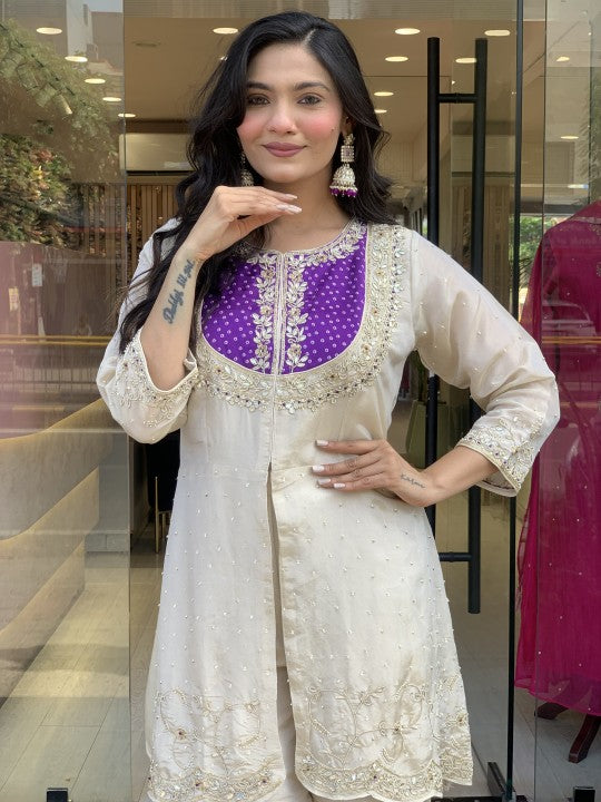 Close-up of model in K501 set, featuring intricate purple coding sequence embroidery on the round neckline and full sleeves.