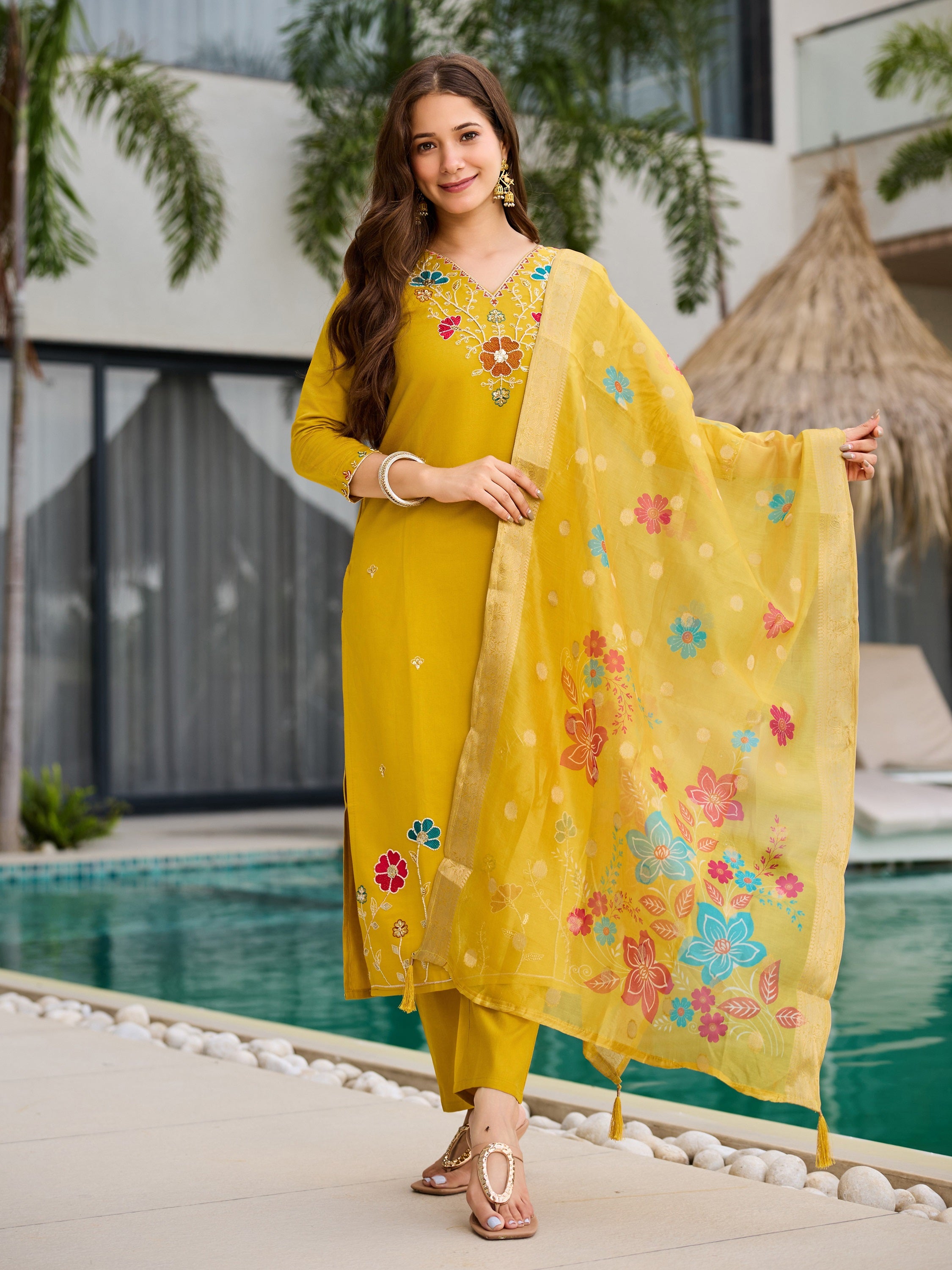 Model in vibrant yellow embroidered viscose kurta set by poolside, showcasing full outfit.