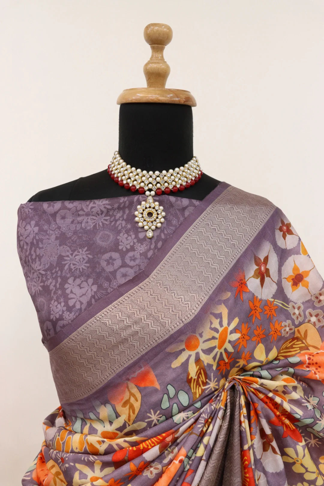 Latest designer printed Dola silk saree, highlighting its unique pattern and matching blouse fabric.