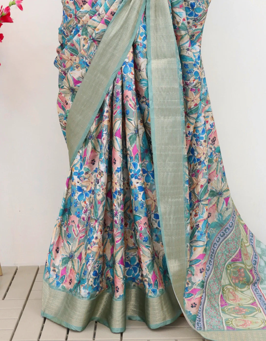 Model wearing latest designer digital printed saree with a unique floral pattern and matching blouse.