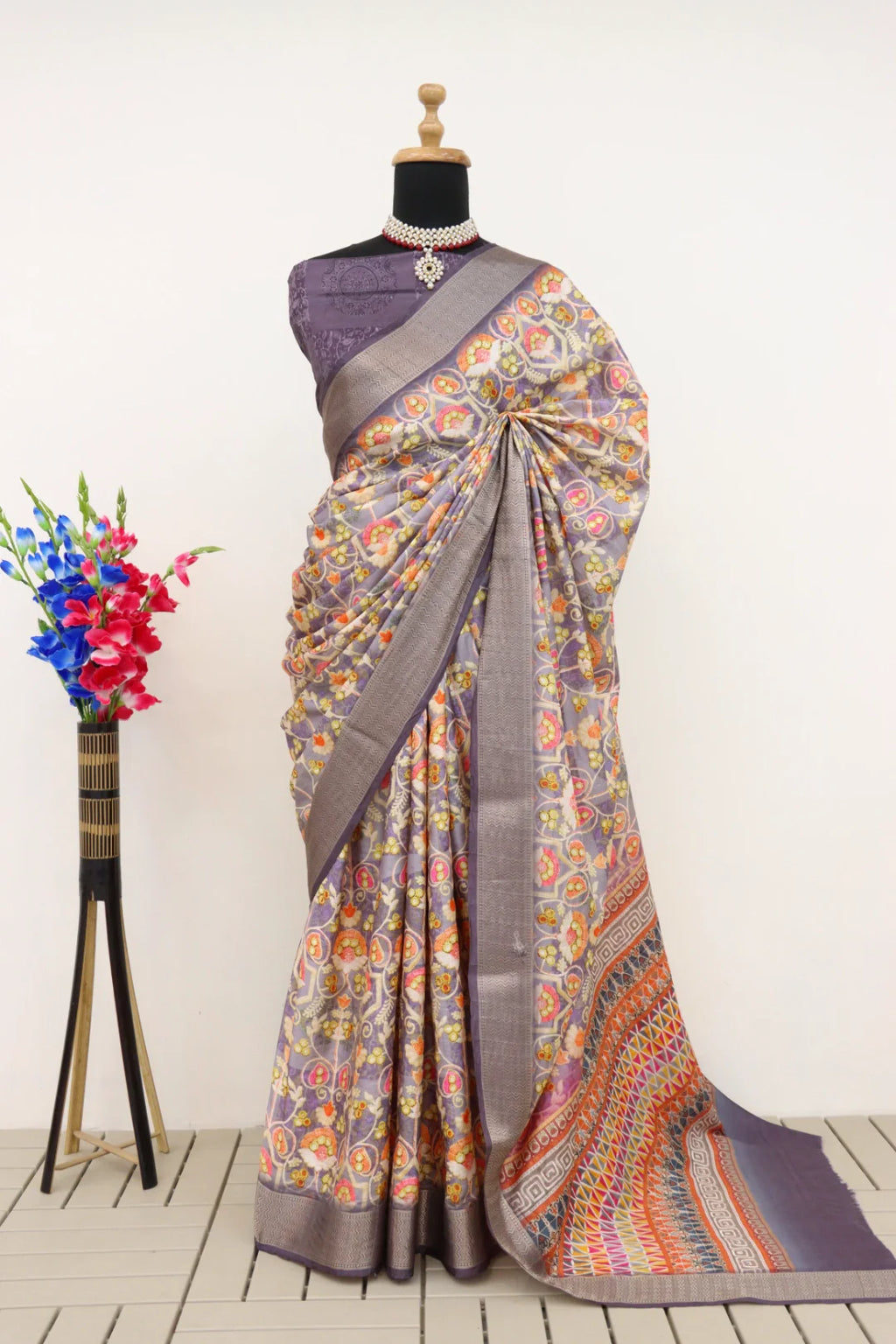 Close-up of intricate digital floral prints on soft purple silk fabric.