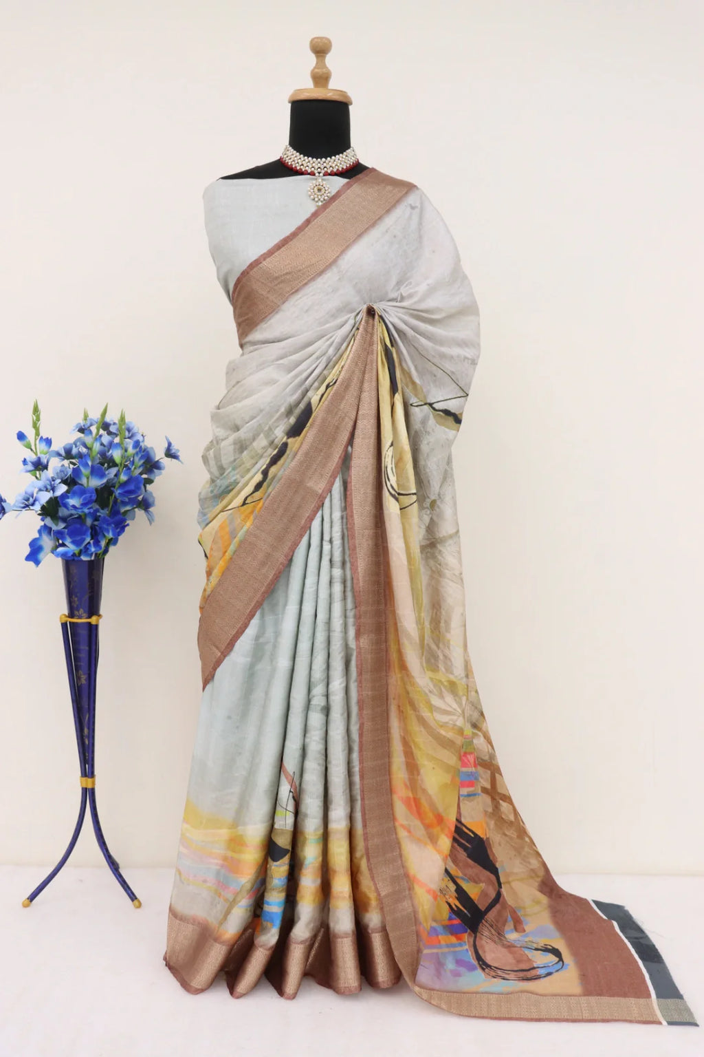 Close-up of the intricate silver-grey digital prints on the saree body