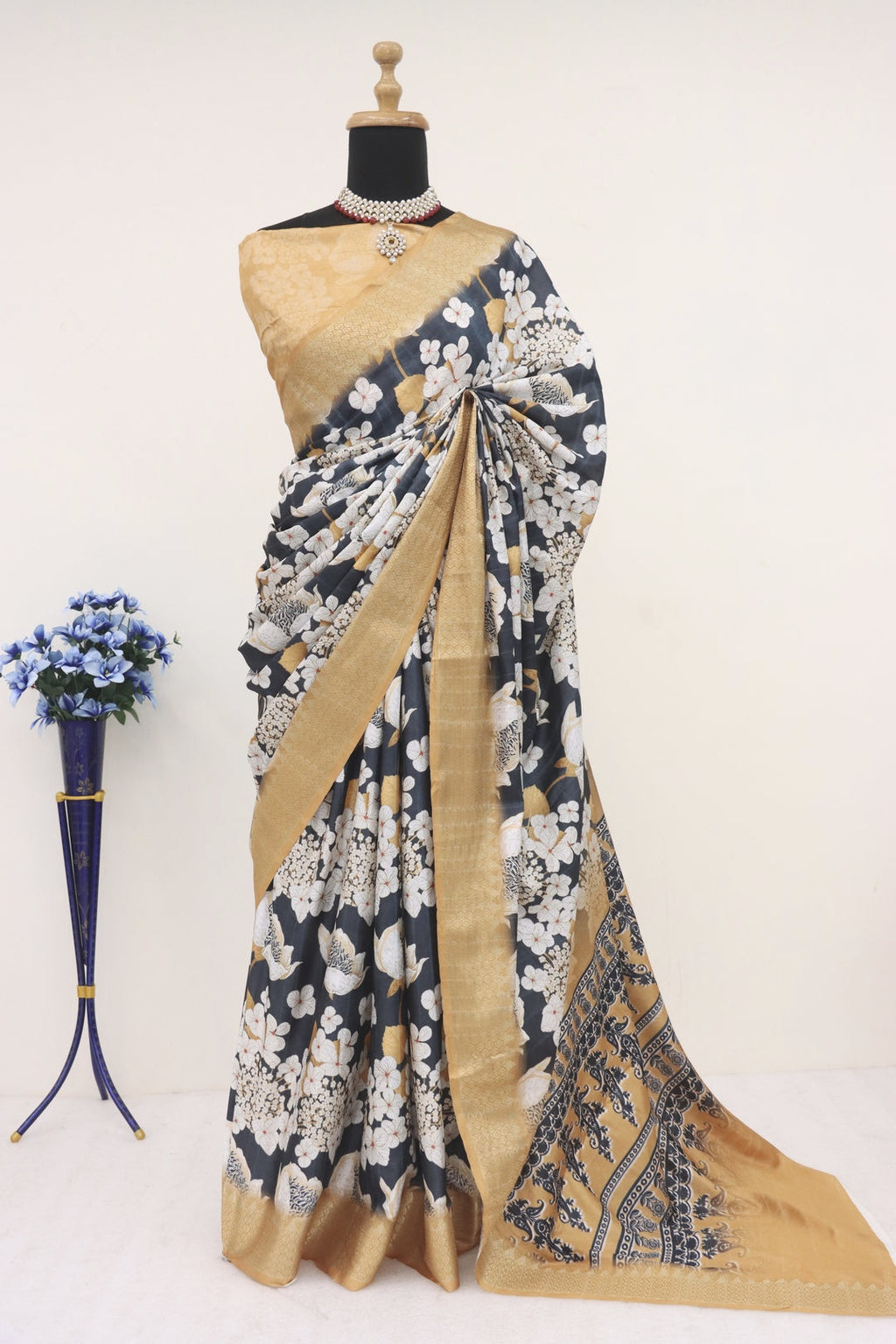 Gold and black printed silk saree with intricate patterns and luxurious drape.