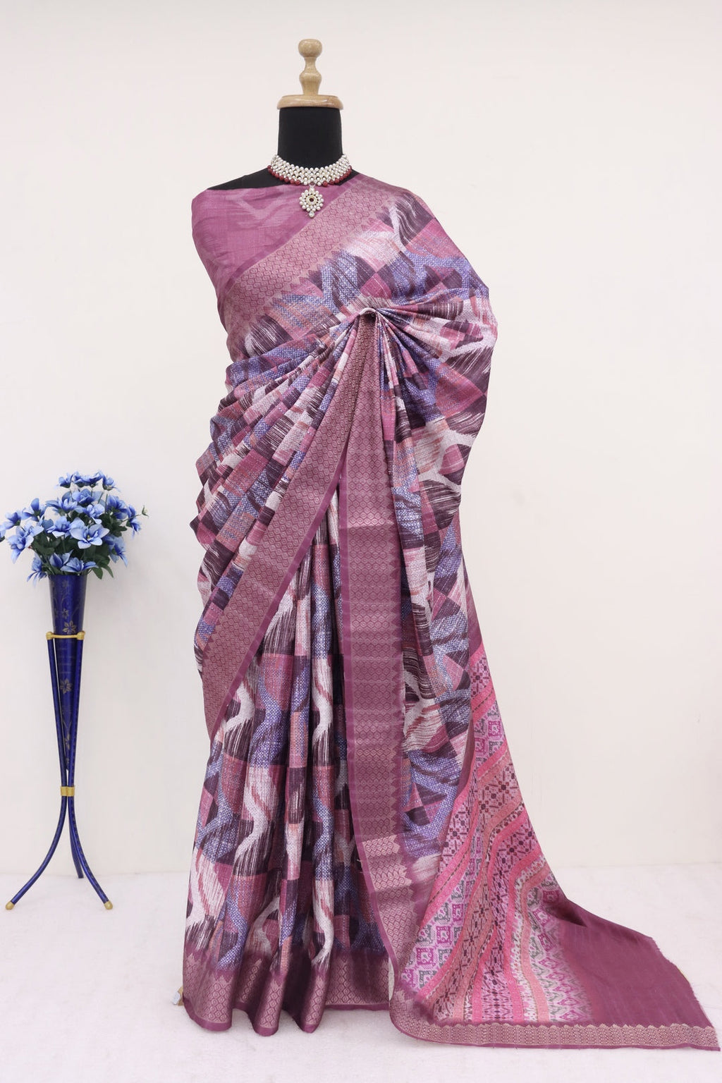 Purple printed Saree, showcasing its intricate patterns and vibrant color.