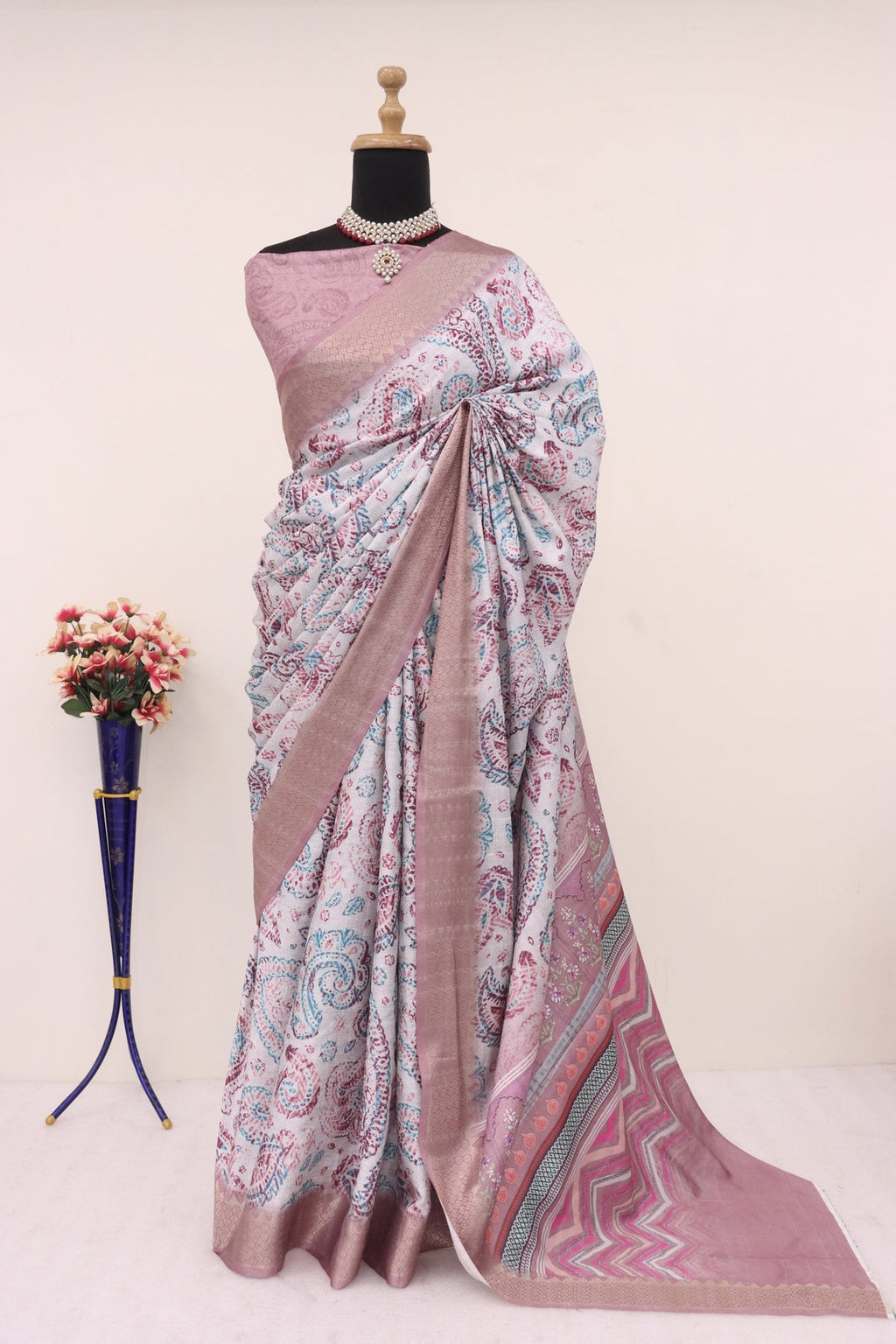 Close-up of the intricate gold Banarasi zari border on the chocolate brown silk fabric