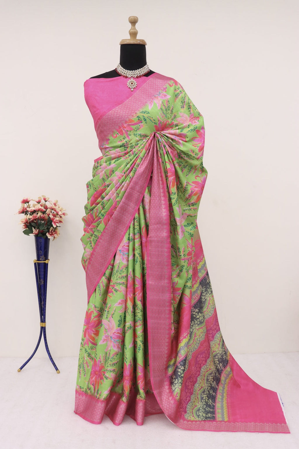 Close-up of intricate gold Banarasi zari motifs on the pink border
