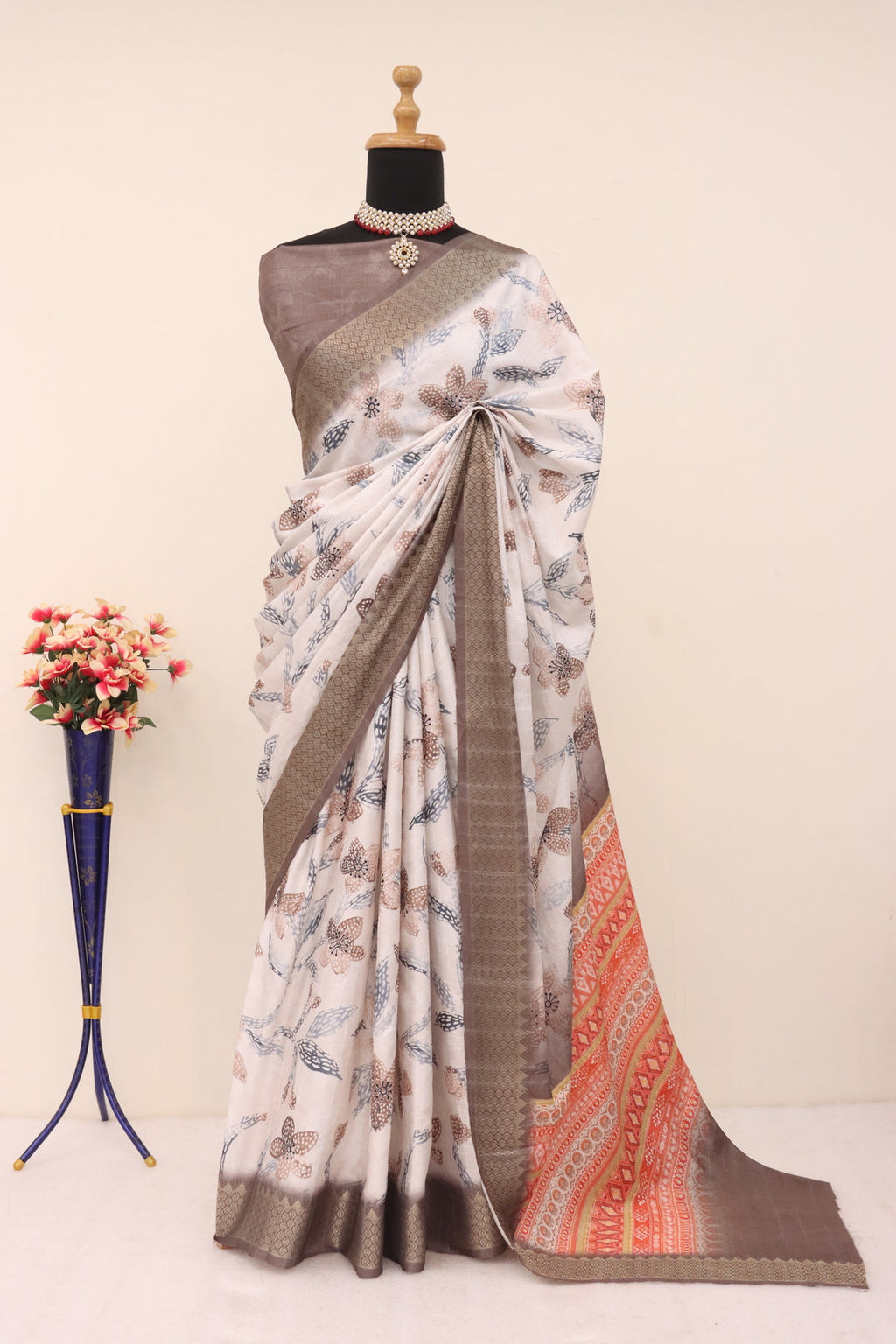 Woman wearing a white brown printed silk saree