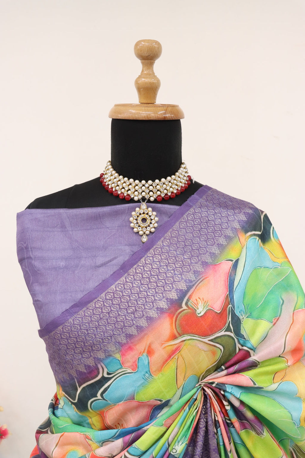 Close-up of intricate digital prints and gold zari work on lavender fabric