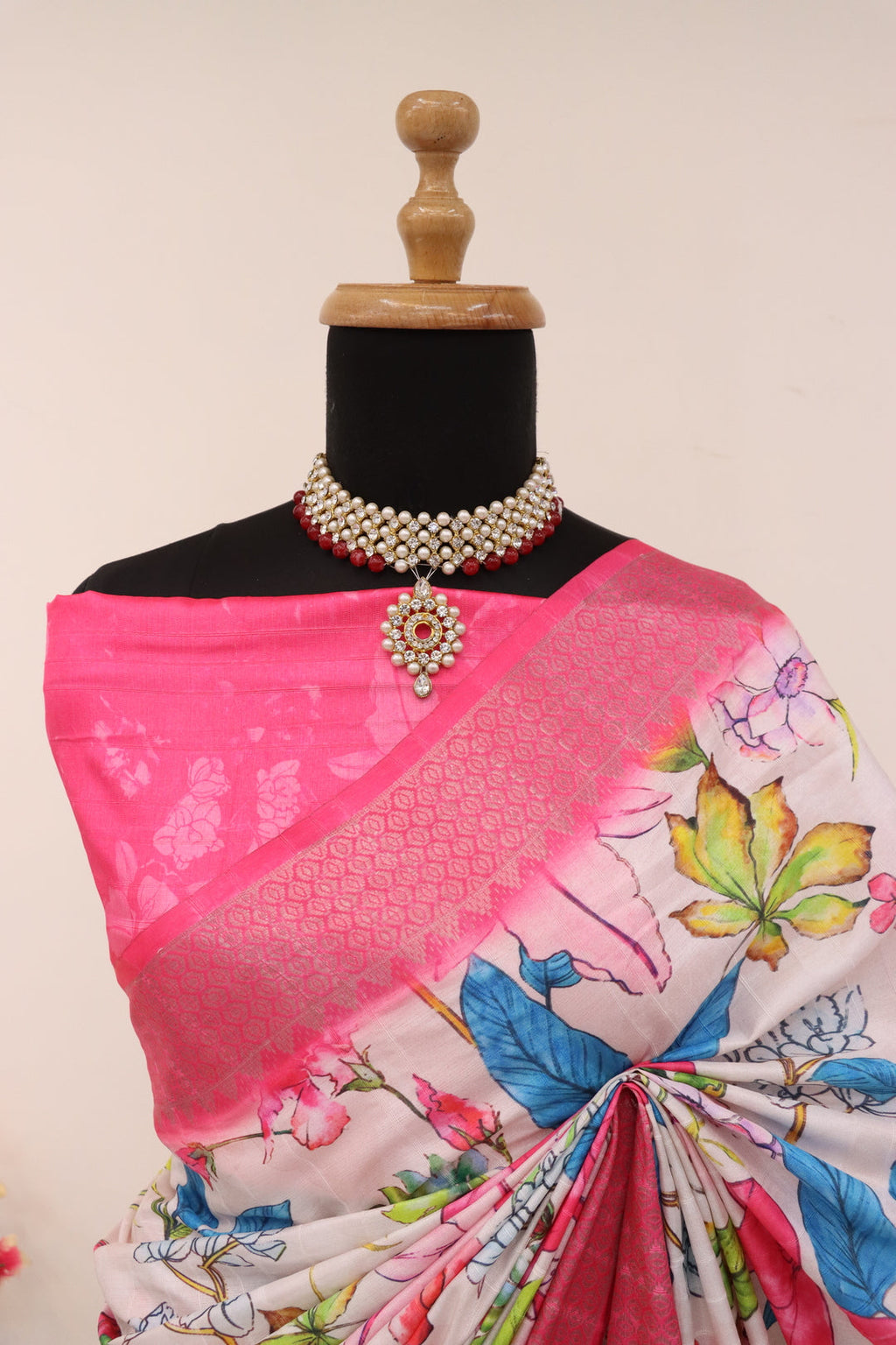 Close-up of vibrant digital floral prints on soft pink silk fabric