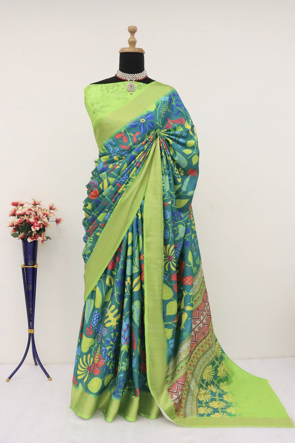 Model wearing a light green printed saree with a detailed pattern