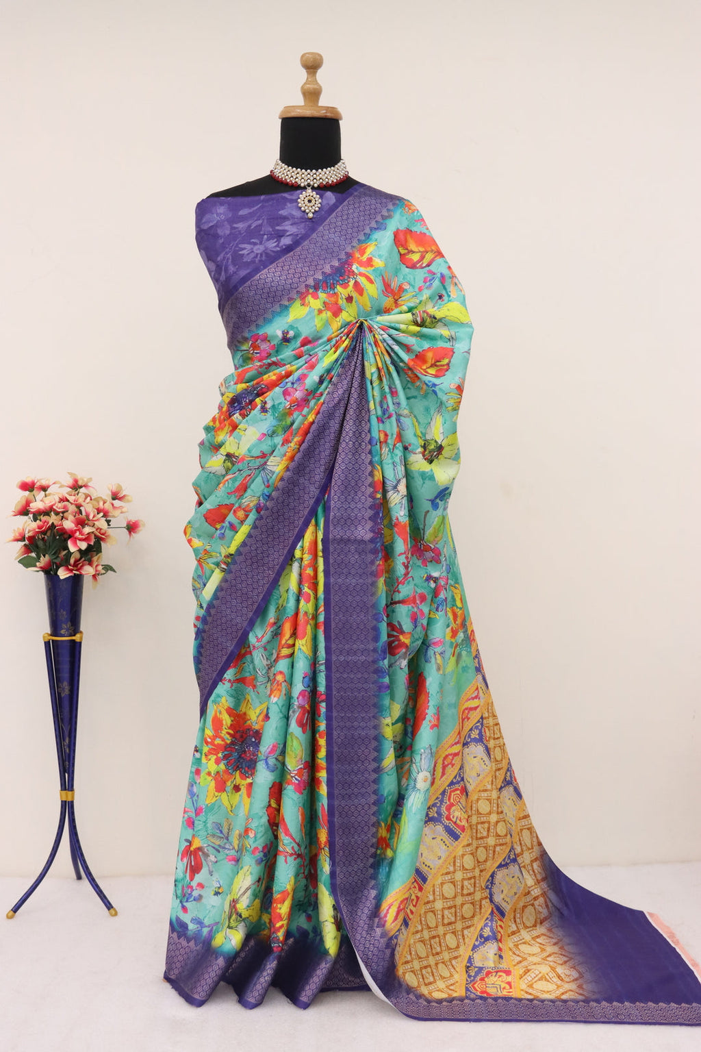 Elegant navy blue printed saree draped on a model, displaying its intricate design.
