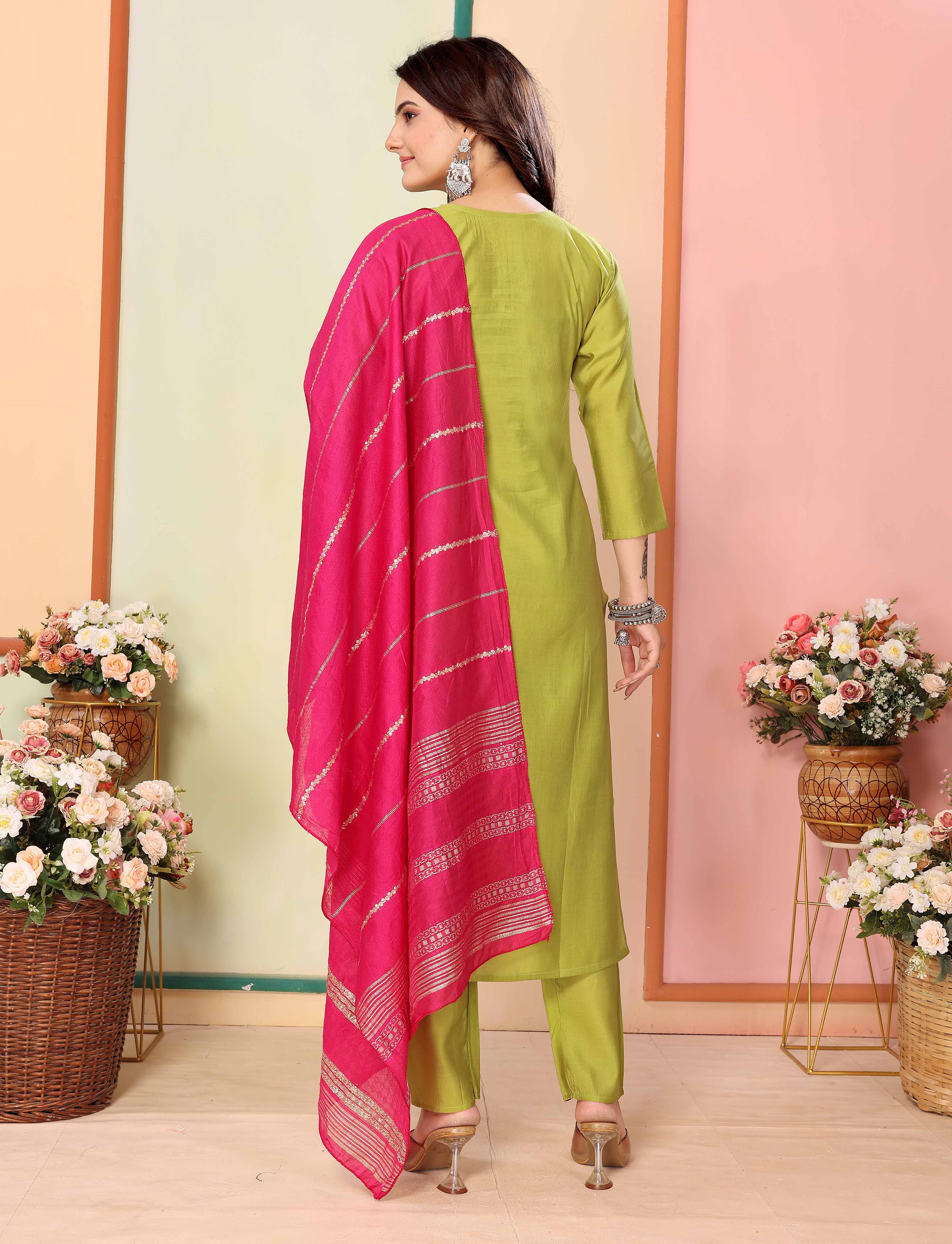 Rear view of model in lime green silk kurta and pants with pink dupatta, highlighting the flow and simple elegance of the outfit from TRENDBUY's Pavitra collection.