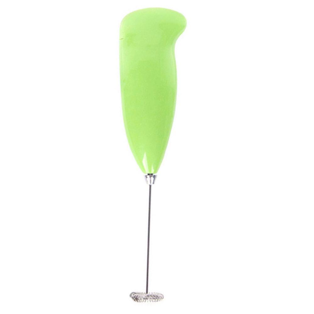 Electric handheld milk frother making creamy foam for latte and coffee